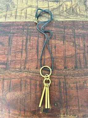 Gold Tassel Necklace on Black Cord. Costume jewelry.